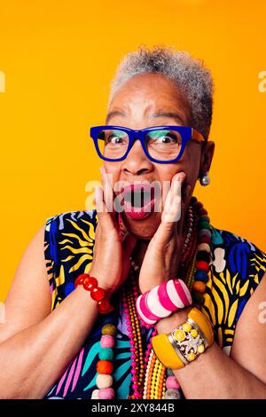Colorful portrait of funny senior black woman wearing stylish clothing isolated in studio - Cool moder old female adult, concepts about elderly, senio Stock Photo
