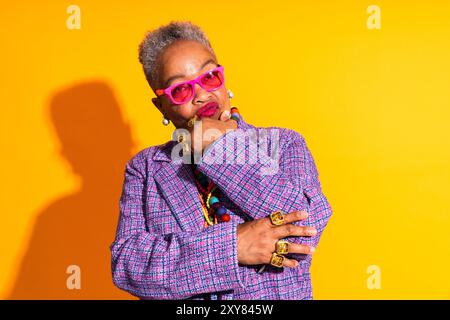 Colorful portrait of funny senior black woman wearing stylish clothing isolated in studio - Cool moder old female adult, concepts about elderly, senio Stock Photo