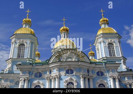 Beautiful baroque church with golden domes and crosses against a blue sky Stock Photo