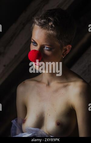 Woman wears a red clown nose Stock Photo