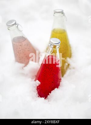 Three healthy drinks with chia seeds (lat. Salvia hispanica) ion the snow. Health and diet concept. Chia seeds are considered a superfood containing p Stock Photo