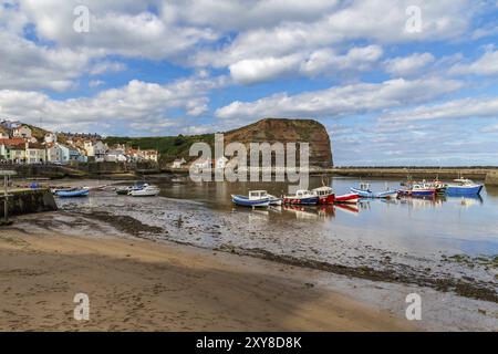 Staithes, North Yorkshire, England, UK, September 07, 2016: View from the beach towards Staithes Beck and the Lifeboat Station, with some boats on the Stock Photo