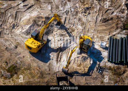 Aerial photograph of heavy machinery, two excavators working on construction stie. February 7, 2024. Stock Photo