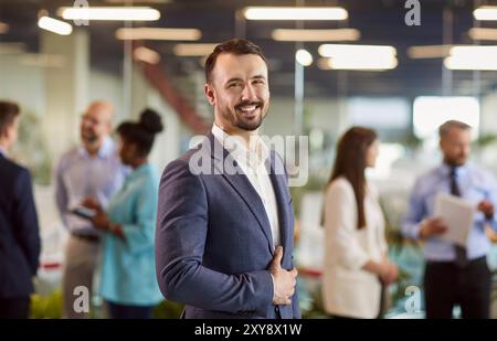 Confident young businessman looking at camera, portrait Stock Photo