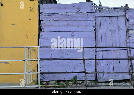 650 Colorist walls of Colonial house featuring a nice color contrast of purplish-blue and yellow, Calle Maceo Street, Regla municipality. Havana-Cuba. Stock Photo