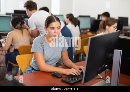 Woman learning to use software in computer class Stock Photo