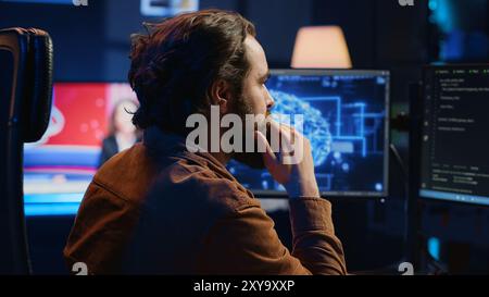 Computer scientist writes code on PC to visualize artificial intelligence neural networks. Remote IT worker runs AI script for information processing from personal office, camera A Stock Photo