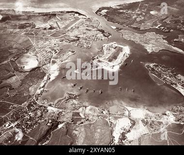 Aerial view of the Naval Operating Base, Pearl Harbor, October 30,1941, just over one month before the Japanese attack. Ford Island Naval Air Station is in the center, with the Pearl Harbor Navy Yard just beyond it, across the channel. The airfield in the upper left-center is the Army's Hickam Field. Stock Photo