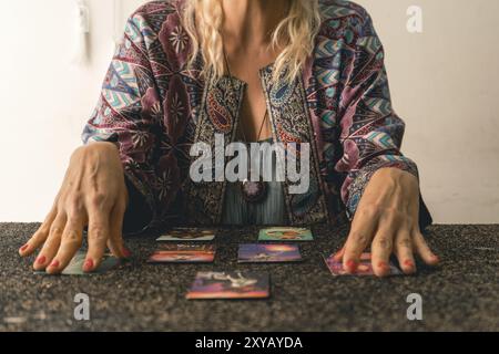 Close-up of a tarot reader's hands as she interprets the messages from the cards Stock Photo