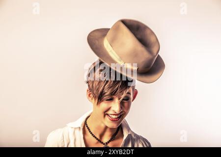 Hat is thrown on a woman's head Stock Photo