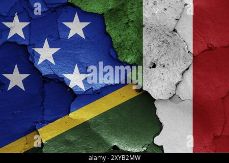 Flags of Solomon Islands and Italy painted on cracked wall Stock Photo