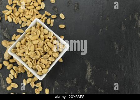 Roasted and salted Peanuts on vintage background (close-up shot, selective focus) Stock Photo