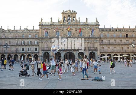 Street artists and children playing in the Plaza Mayor, behind the town hall, Salamanca, province of Salamanca, Castile and Leon, Spain, Europe Stock Photo