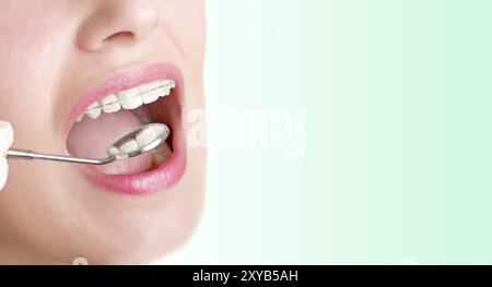 Closeup of a dentist hands about to do a procedure on a patient in a green background Stock Photo