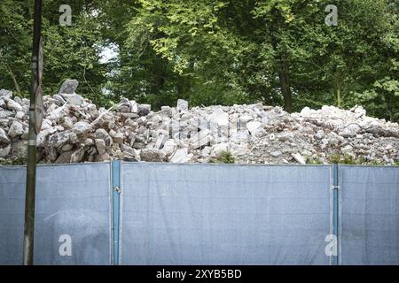 Rubble from a demolished building behind a construction fence in Duesseldorf, Germany, Europe Stock Photo