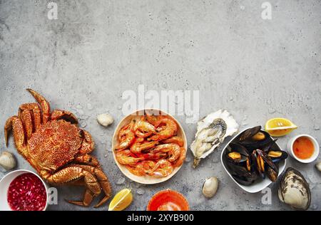 Freshly variety of sea food on the gray kitchen table. Top view Stock Photo