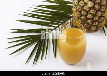 Glass of pineapple juice and whole fruit on white background Stock Photo