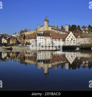 Autumn scene in Schaffhausen, Switzerland. Medieval castle Munot and old houses reflecting in the river Rhine Stock Photo