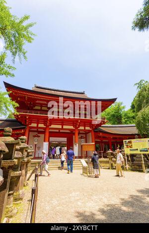 NARA, JAPAN, JUNE 24, 2015: People entering front door gate of Kasuga-Taisha Shinto shrine on Todai-ji temple complex in Nara, Japan, Asia Stock Photo