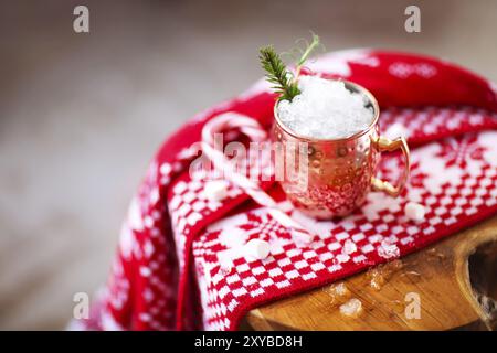 Cold Moscow Mules cocktail with ginger beer, vodka, lime and ice on the plaid background Stock Photo