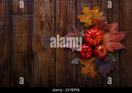 Autumn decorations on old wooden background, pumpkins and dried leaves with copy space Stock Photo