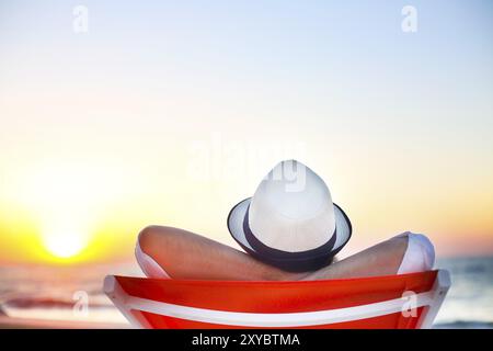 Young man relaxing on the beach back view. Summer vacation. Relax concept Stock Photo