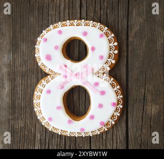 Cookies number eight. Gingerbread cookie on the rustic wooden background Stock Photo