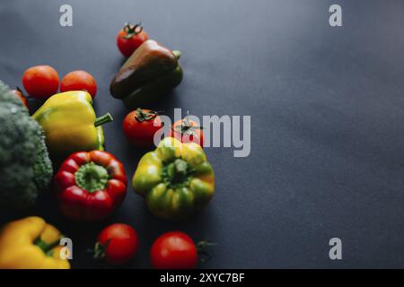 Fresh green broccoli and other vegetables, drops of water on broccoli. Gray background. Stock Photo
