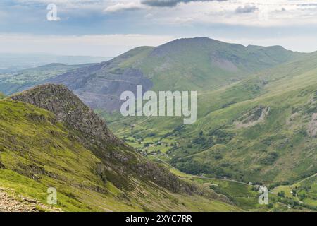 Walking down from Mount Snowdon on the Llanberis Path, Snowdonia, Gwynedd, Wales, UK, looking north towards the derelict Dinorwic Quarry Stock Photo