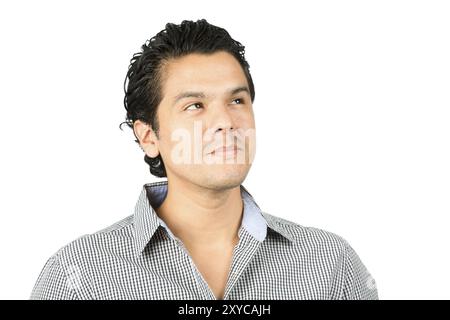 Portrait of a thinking, reserved, hispanic man in casual clothes looking up to the side at blank copy space or product placement with pensive facial e Stock Photo