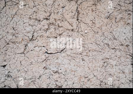 Old cracked wall made of orange clay and straw. Stock Photo