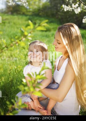 Happy mother and her little daughter in the spring day Stock Photo