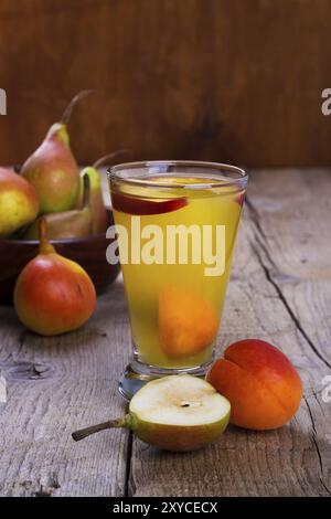Home made juice with pear, apricot, peach and cherries. Selective focus Stock Photo
