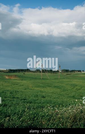 Rainbow over a field of young wheat Stock Photo