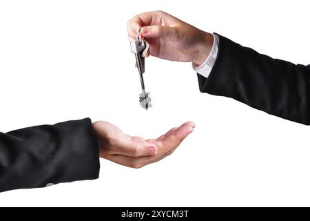 A hand giving a key to another hand. Both persons in suits. Isolated Stock Photo