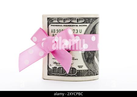 A stack of 100-dollar bills with a holiday bow isolated on white Stock Photo