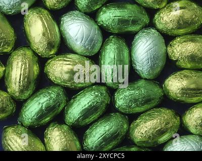 Chocolate eggs in green tin foil Stock Photo