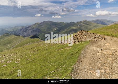 Walking down from Mount Snowdon on the Llanberis Path, Snowdonia, Gwynedd, Wales, UK, looking north towards Llyn Padarn and Llanberis Stock Photo