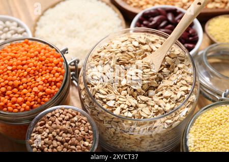 Different types of cereals and legumes on table, closeup Stock Photo