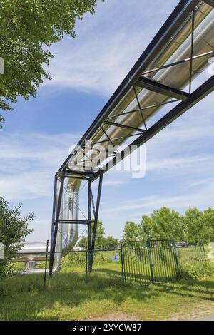 Large metal gas pipeline through blue sky Stock Photo