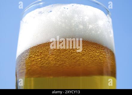 Closeup of freshly tapped bavarian beer in front of blue sky Stock Photo