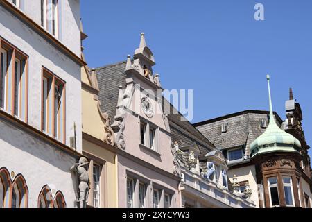 Detail of the ancient colorful houses of Market Square in Trier, Germany. These buildings are decorated with statues Stock Photo