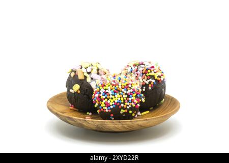 Closeup of sweet chocolate cupcake in a wooden plate on white background Stock Photo