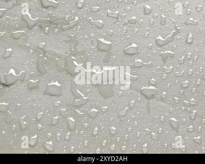 Water drops on Tofu colored metallic surface Stock Photo