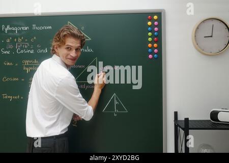 Explaining Pythagorean Theorem on Chalkboard in Classroom Stock Photo