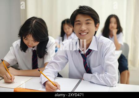 Smiling Student Studying in Classroom Looking at Camera Stock Photo