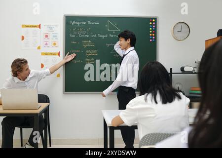 Explaining Pythagorean Theorem on Chalkboard in Classroom Stock Photo