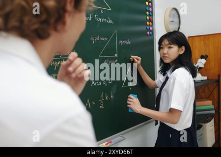 Student Engaging in Geometry Class Discussion at Board Stock Photo