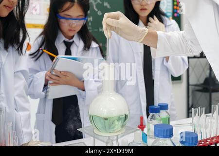 Conducting Chemistry Experiment in Science Classroom Stock Photo