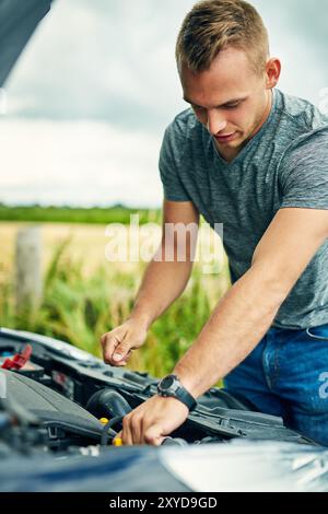 Man fixing car on road. Car Breakdown while driving. Driver looks on ...